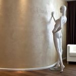 Скульптура у стены с декоративной штукатуркой